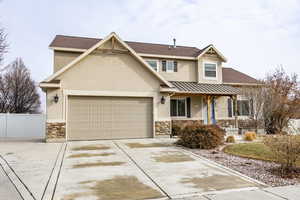 View of front of house with a garage and covered porch