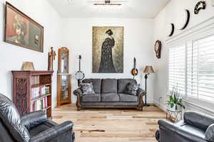 Living room featuring hardwood / wood-style flooring, plenty of natural light, and rail lighting