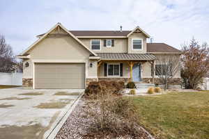 View of front of home with a garage and a front yard