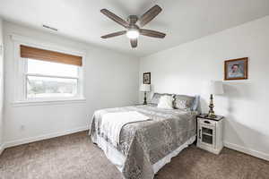 Bedroom featuring ceiling fan and carpet floors