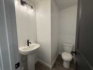 Bathroom featuring hardwood / wood-style floors and toilet