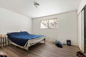 Bedroom with wood-type flooring and a closet