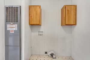 Laundry area with electric dryer hookup, cabinets, and hookup for a washing machine