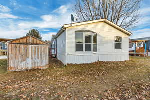 View of property exterior featuring an outbuilding