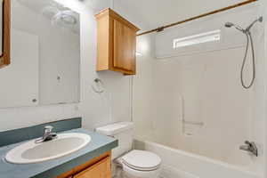 Full bathroom with vanity, shower / bath combination, and toilet