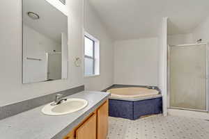 Bathroom featuring vanity and plus walk in shower