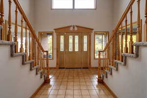 Foyer entrance with light tile patterned flooring