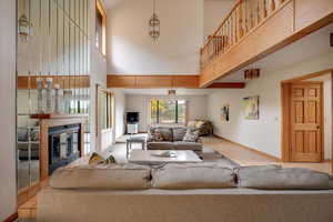 Tiled living room featuring a high ceiling