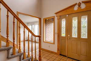 Entrance foyer featuring light tile patterned flooring