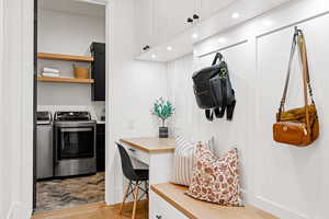 Interior space with white cabinets, separate washer and dryer, and light hardwood / wood-style flooring