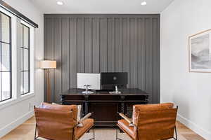 Home office with light hardwood / wood-style floors