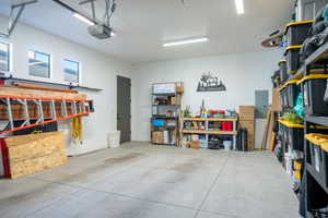 Garage featuring electric panel and a garage door opener