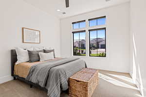 Carpeted bedroom with ceiling fan