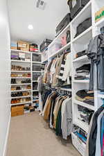 Walk in closet with light carpet