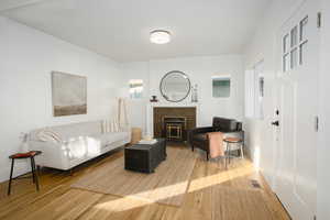 Living room with a original fireplace and real classic hardwood.