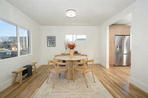 Dining area featuring plenty of natural light and light wood-type flooring