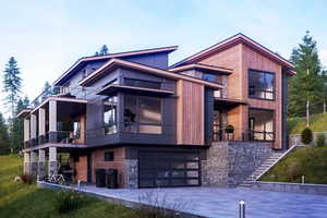 View of front of home featuring a balcony and a garage