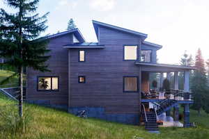 View of property exterior featuring a yard and a wooden deck