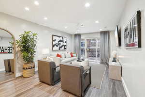 Living room featuring ceiling fan and light wood-type flooring