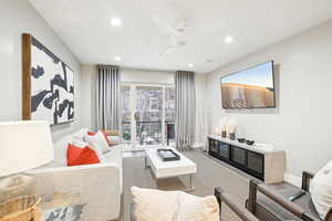 Living room with wood-type flooring and ceiling fan