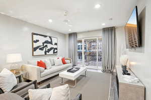 Living room featuring ceiling fan and wood-type flooring