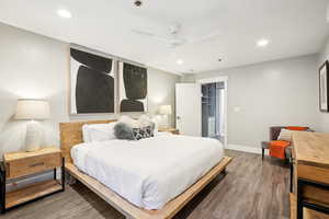 Bedroom with ceiling fan, a closet, a spacious closet, and hardwood / wood-style flooring