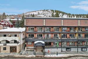 Snow covered building with a mountain view