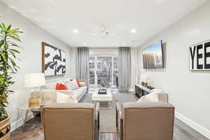 Living room with hardwood / wood-style flooring and ceiling fan