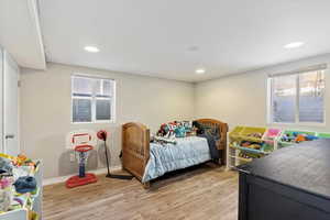 Bedroom with light hardwood / wood-style flooring