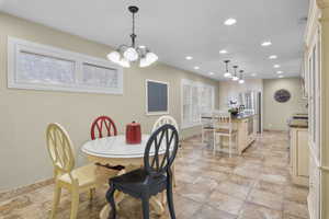 Dining area in upstairs kitchen with a chandelier