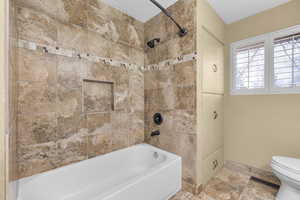 Upstairs Bathroom with tiled shower / bath combo