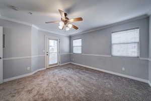 Primary Suite with carpet flooring, ceiling fan, and ornamental molding