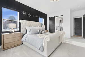 Primary bedroom featuring a barn door into the primary bath.