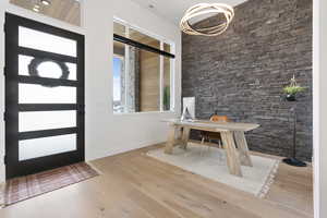 Foyer entrance/office with hardwood flooring and a rock accent wall.