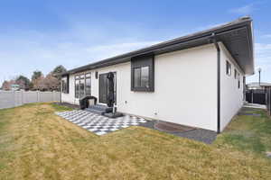 Back of property featuring a yard and a patio