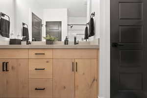 Bathroom with a tub/shower combo and vanity