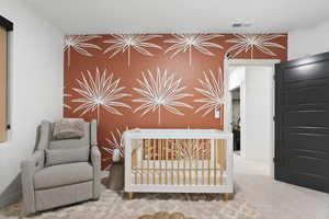 Carpeted bedroom with accent wall.