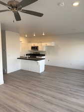 Kitchen with ceiling fan, white cabinetry, and stainless steel appliances