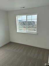 Unfurnished room featuring carpet floors