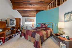 Bedroom with carpet, lofted ceiling, and wooden ceiling