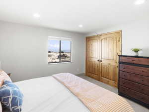 Bedroom featuring light colored carpet