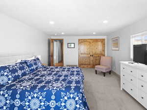 Bedroom featuring light carpet