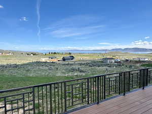 Wooden deck featuring a rural view and a mountain view