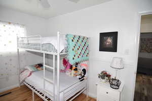 Bedroom #2 featuring ceiling fan and wood flooring