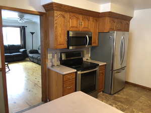 Kitchen with ceiling fan and stainless steel appliances