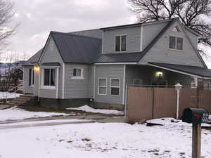 View of snow covered back of property