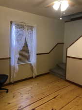 Interior space with hardwood / wood-style flooring and ceiling fan