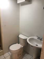 Bathroom with tile patterned floors and toilet