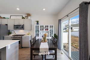 Kitchen featuring gray cabinets, light hardwood / wood-style floors, and stainless steel appliances