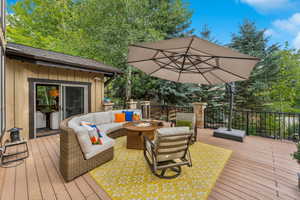 Wooden deck with an outdoor living space with a fire pit